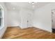 A bright bedroom featuring hardwood floors, recessed lighting, and a white door at 1129 Victory Sw Dr, Atlanta, GA 30310