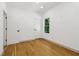 Bright bedroom features hardwood floors, white walls, and a modern window at 1129 Victory Sw Dr, Atlanta, GA 30310
