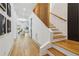 Hardwood floors lead to a staircase featuring wood railings and trim at 1129 Victory Sw Dr, Atlanta, GA 30310