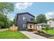 Two-story home with vertical siding, a well-manicured lawn, and a paved driveway at 1129 Victory Sw Dr, Atlanta, GA 30310