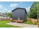 Contemporary home exhibits dark siding and a charming wooden deck at 1129 Victory Sw Dr, Atlanta, GA 30310