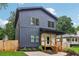 Charming two-story home with vertical siding, a covered porch, and manicured landscaping at 1129 Victory Sw Dr, Atlanta, GA 30310