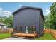 Modern home showcases striking dark siding and a quaint wooden deck at 1129 Victory Sw Dr, Atlanta, GA 30310