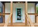 A close-up view of a front door with a light blue frame and wood porch at 1129 Victory Sw Dr, Atlanta, GA 30310