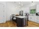 Kitchen with large island, stainless steel appliances, wine cooler, and contemporary lighting at 1129 Victory Sw Dr, Atlanta, GA 30310