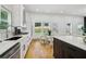 Stainless steel appliances and white cabinets surround an eat-in area and backyard view at 1129 Victory Sw Dr, Atlanta, GA 30310