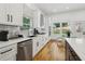 White cabinets and stainless steel appliances with eat-in area and backyard view at 1129 Victory Sw Dr, Atlanta, GA 30310