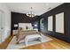 Main bedroom with hardwood floors, designer lighting, and modern decor at 1129 Victory Sw Dr, Atlanta, GA 30310