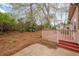 Backyard featuring the back deck, unfenced lawn and scattered trees at 134 N Alexander St, Buford, GA 30518