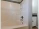 Bathroom featuring tub with showerhead, white tiling, and partial view of sink/vanity at 134 N Alexander St, Buford, GA 30518