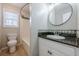 Bright bathroom with tile flooring, vanity with granite countertop, sink, toilet and shower at 134 N Alexander St, Buford, GA 30518