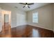 Bedroom with hardwood floors, a window, ceiling fan, and a closet with white doors at 134 N Alexander St, Buford, GA 30518