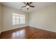 Bedroom featuring hardwood floors, a ceiling fan, and a large window at 134 N Alexander St, Buford, GA 30518