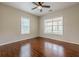 Bedroom with ceiling fan, hardwood floors, and two large windows at 134 N Alexander St, Buford, GA 30518