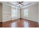 Spacious bedroom featuring hardwood floors, recessed lighting, and custom built-in shelving at 134 N Alexander St, Buford, GA 30518