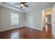 Neutral bedroom with hardwood floors, ceiling fan, and attached room at 134 N Alexander St, Buford, GA 30518