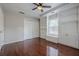 Bedroom with hardwood floors, closet, window seating, and white built-in shelving at 134 N Alexander St, Buford, GA 30518