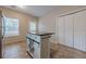 Kitchen area featuring an island with dark wood countertop, cabinet space, and stainless steel refrigerator at 134 N Alexander St, Buford, GA 30518