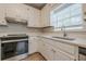 Bright kitchen featuring white cabinets, stainless steel appliances and plenty of countertop space at 134 N Alexander St, Buford, GA 30518