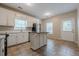 Bright eat-in kitchen with white cabinets, stainless steel appliances, tile floors and center island at 134 N Alexander St, Buford, GA 30518