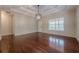 Large living room with hardwood floors, recessed lighting, modern light fixture, and large windows to the exterior at 134 N Alexander St, Buford, GA 30518