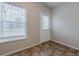 Neutral room with tile floors, large windows and white door leading to the exterior at 134 N Alexander St, Buford, GA 30518