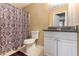 This bathroom features a shower curtain, granite countertop, white cabinets, and a toilet at 2996 Jonesboro Road Southeast Se Rd # J, Atlanta, GA 30354