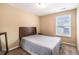 Neutral bedroom featuring a bed with patterned bedding, carpet, and a window for natural light at 2996 Jonesboro Road Southeast Se Rd # J, Atlanta, GA 30354