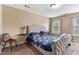 Spacious bedroom with a bed, side table, and natural light from the two windows at 2996 Jonesboro Road Southeast Se Rd # J, Atlanta, GA 30354