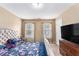 Well-lit bedroom with carpeting, TV, and a neutral color palette for a calming atmosphere at 2996 Jonesboro Road Southeast Se Rd # J, Atlanta, GA 30354