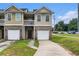 Inviting townhouse with attached garage, balcony, and a well-maintained lawn at 2996 Jonesboro Road Southeast Se Rd # J, Atlanta, GA 30354