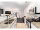 Modern kitchen with granite countertops, stainless steel appliances, and open floor plan at 2996 Jonesboro Road Southeast Se Rd # J, Atlanta, GA 30354
