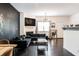 Stylish living room with a chalkboard accent wall, modern lighting and dark wood floors at 2996 Jonesboro Road Southeast Se Rd # J, Atlanta, GA 30354