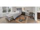 Bright bedroom featuring a large window, tufted headboard bed, bench, and stylish decor at 3504 Castleberry Village Cir # 36, Cumming, GA 30040
