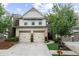 Charming two-story home featuring a two-car garage, neutral siding, and a well-manicured lawn at 3504 Castleberry Village Cir # 36, Cumming, GA 30040