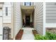Inviting front porch with a black door, neutral siding, and decorative touches for added curb appeal at 3504 Castleberry Village Cir # 36, Cumming, GA 30040