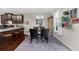 Open-concept kitchen and dining area with black table set and plenty of natural light at 3504 Castleberry Village Cir # 36, Cumming, GA 30040