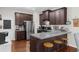 Modern kitchen featuring stainless steel appliances, dark cabinetry, granite countertops, and breakfast bar seating at 3504 Castleberry Village Cir # 36, Cumming, GA 30040
