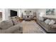 Bright and spacious living room featuring hardwood floors, comfortable seating, and a large area rug at 3504 Castleberry Village Cir # 36, Cumming, GA 30040