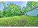 Large, grassy backyard partially enclosed by a chain-link fence, with mature trees at 4457 Lincoln Jones Rd, Ellenwood, GA 30294