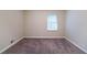 The cozy bedroom features neutral walls, carpet flooring, and a window that brings in natural light at 4457 Lincoln Jones Rd, Ellenwood, GA 30294