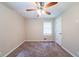 A cozy bedroom features neutral walls, carpet flooring, and a ceiling fan for added comfort at 4457 Lincoln Jones Rd, Ellenwood, GA 30294