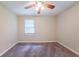This inviting bedroom has neutral walls, carpet flooring, and a window with natural light at 4457 Lincoln Jones Rd, Ellenwood, GA 30294