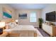 A staged bedroom features modern decor, including stylish furniture and elegant wall art at 4457 Lincoln Jones Rd, Ellenwood, GA 30294