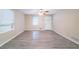 Neutral living room with a fan, large windows and a white entry door at 4457 Lincoln Jones Rd, Ellenwood, GA 30294