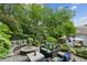 Inviting backyard featuring a fire pit, custom bench seating, a dining area and beautiful greenery at 797 Ashland Ne Ave, Atlanta, GA 30307