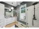 Modern bathroom with sleek vanity, stylish lighting, glass shower, and subway tile at 797 Ashland Ne Ave, Atlanta, GA 30307