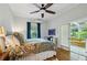 Cozy bedroom with hardwood floors, ceiling fan, and access to a sunroom with comfortable yellow couch at 797 Ashland Ne Ave, Atlanta, GA 30307