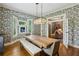 Open dining room featuring a large wooden table, hardwood floors, and easy access to other living spaces at 797 Ashland Ne Ave, Atlanta, GA 30307