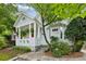 Charming home featuring a covered front porch, beautiful landscaping, and a quaint, historic design at 797 Ashland Ne Ave, Atlanta, GA 30307